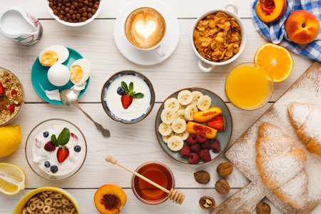 Breakfast Spread With Fruits, Yogurt, and Pastries on a Wooden Table in the Morning