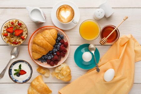 Breakfast Collection Showing Various Foods and Drinks on a Wooden Table
