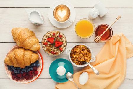Breakfast Collection on a Table With Various Food Items, Drinks, and Utensils in a Calm Setting