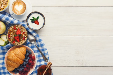 Enjoying Breakfast With a Collection of Food Items on a Checkered Cloth in the Morning Light