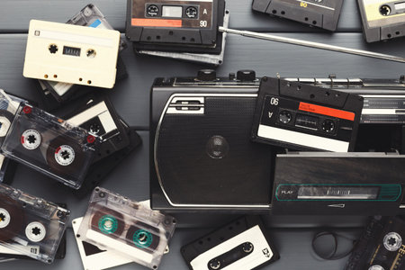 Collection of Cassette Tapes and Radio on a Flat Surface Surrounded by Music Memories