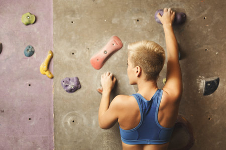 Climber Tackling a Wall at a Rock Climbing Center During an Afternoon Sessionの写真素材