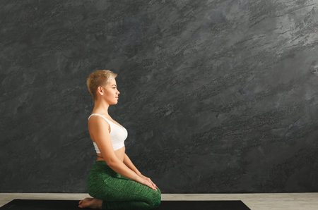 Woman Practicing Yoga in a Studio During Morning Hours for Health and Wellness