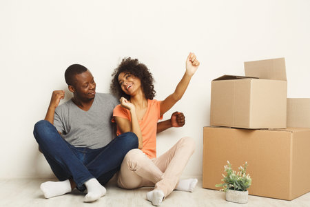 Couple Celebrating New Home With Joy and Excitement in Cozy Living Space