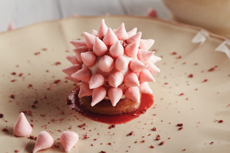 Mosaic of Dessert Creation Featuring a Spiked Meringue on a Plate With Sauce