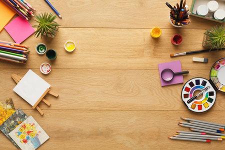 Collage of Art Supplies and Tools on a Wooden Table for Creative Activitiesの写真素材