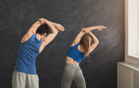 Fitness couple warmup stretching training indoors