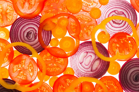 Colorful Slices of Vegetables in a Collage Layout on a White Backgroundの写真素材