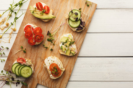 Collection of Vegetable Snacks on a Wooden Board Arranged in a Creative and Colorful Layout