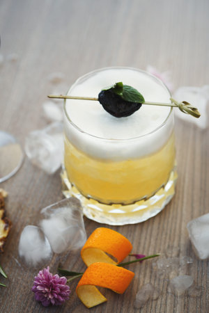 Fresh Drink With Fruit Garnish and Ice on Wooden Table During Sunny Day