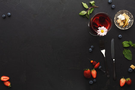 Exploring a Fresh Fruit and Drink Collection on a Dark Surface With Mint and Flowersの写真素材