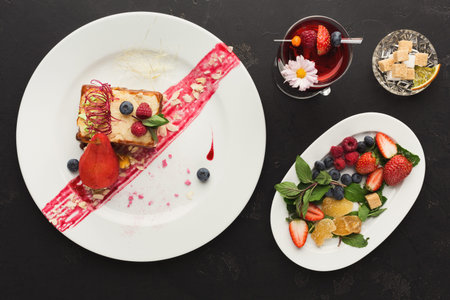 Delicious Dessert and Fruit Collection on a Plate and Table at a Dining Settingの写真素材