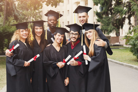 Diverse Graduates Celebrating Academic Achievement Outdoors at a Graduation Ceremony