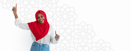 Woman With a Red Headscarf Dancing and Celebrating in a Bright Setting With Floral Patternsの写真素材