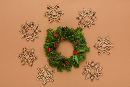 Collage of Christmas Wreath and Snowflake Decorations Arranged on a Plain Background