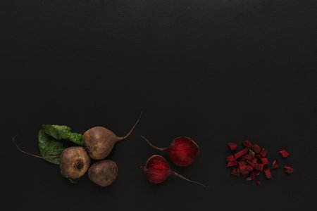 Variety of Beets Arranged on a Dark Surface Showing Different Colors and Cuts
