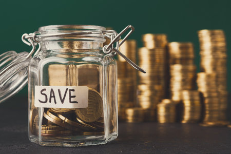A Glass Jar Holds Coins With the Word Save on a Label