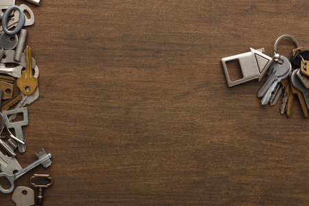 Collection of Keys and Key Shapes Arranged on a Wooden Surface for Creative Display and Design