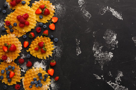 Waffles Topped With Fresh Berries on a Black Surface During a Breakfast Setting