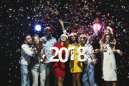 People Celebrate New Year With Confetti and Festive Hats in a Lively Collage From 2018