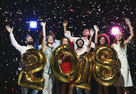 Group Celebration at New Year Party Welcoming 2018 With Joyful Expressions and Confetti