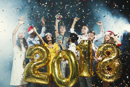 Group Celebration at New Years Party With Gold Balloons and Confetti in a Lively Setting