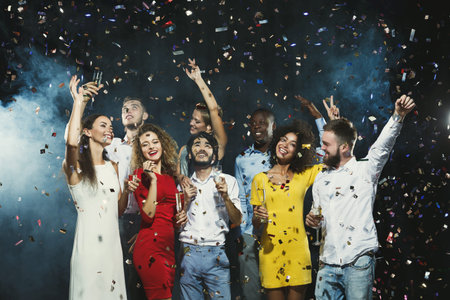 Group of Friends Celebrate With Drinks and Confetti at a Lively Party Event