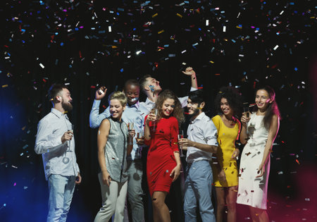 Group of Friends Celebrate at a Party With Confetti Falling in a Lively Setting