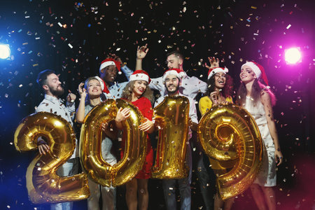 Celebration Event Featuring a Group of Friends Welcoming the New Year 2019 With Colorful Decorations