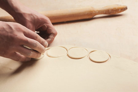 Creating Dough Shapes for Baking Cookies in a Kitchen Setup With a Rolling Pin