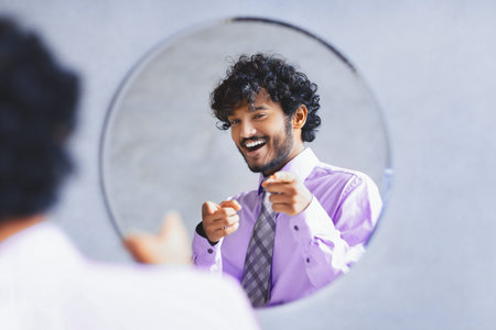 Happy Man Points at Himself in Mirror Wearing a Shirt and Tie in a Casual Setting