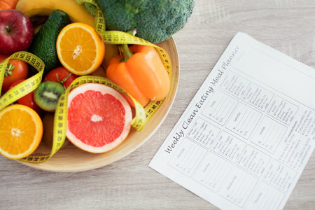 Weekly Clean Eating Meal Planner With Fresh Fruits and Vegetables in a Bowl