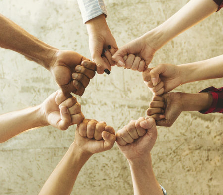 Hands Come Together in a Circle to Represent Unity and Collaboration Among Diverse Individuals
