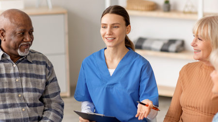 Nurse Talks to Patients in Group Setting at a Healthcare Facility in a Bright Roomの写真素材