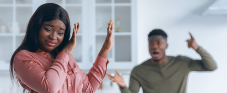 Psychological Abuse. Angry Black Man Shouting At His Scared Girlfriend In Kitchenの写真素材