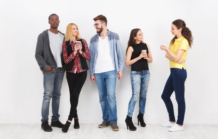Group of friends enjoying casual conversation and drinks indoors
