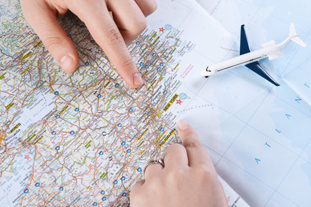 Planning a Trip Using a Physical Map and Model Airplane on a Table