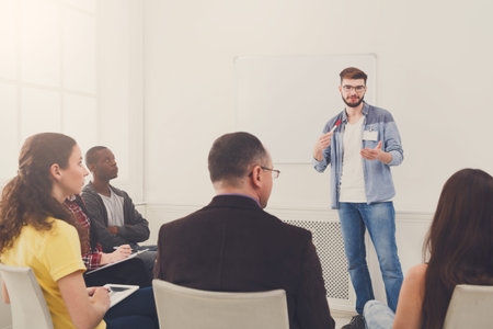 Group Listens to Speaker During Presentation in a Bright Room