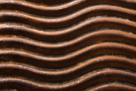 Wavy Metal Surface Showing Rust Patterns and Texture in Close View During Daylight Hours