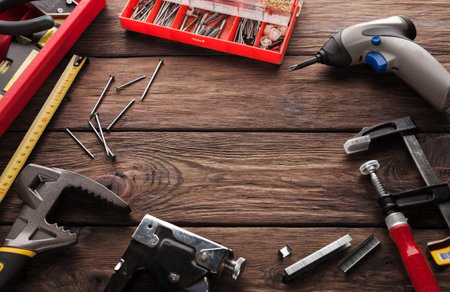 Tools and Equipment Spread Across a Wooden Surface in a Workspace During the Daytime