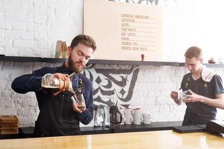 Baristas Pour Coffee and Prepare Drinks in Busy Coffee Shop During Morning Rush