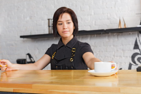 Barista Prepares Coffee for Customer at Cafe During Busy Afternoon in Urban Area