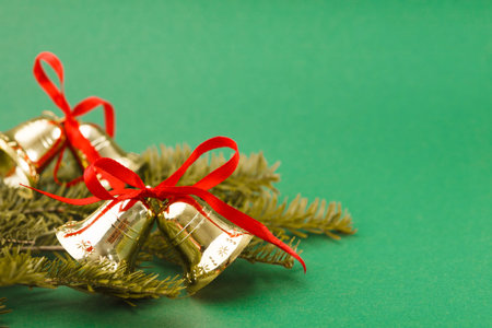 Collection of Golden Bells With Red Ribbons on Green Backdrop for Decoration