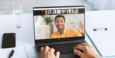 Doctor Types on Laptop During Remote Work Session With Conference Call Discussion