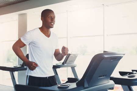 Man Running on Treadmill in Gym During Morning Workout Session for Fitness and Health