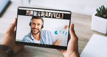 Young African American Male Uses Tablet for Work in Home Office During Video Call Meeting