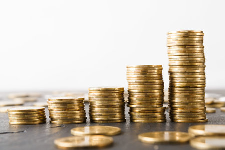 Collections of Coins Stacked in Different Heights Showing Growth in Savings Over Time