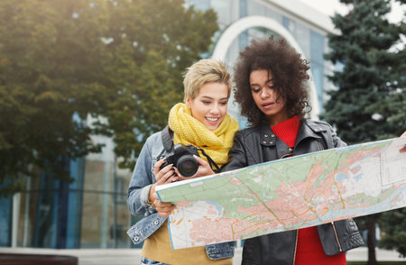 Friends Explore City While Looking at Map and Enjoying Their Adventure Together