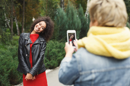 Collage of Two People Sharing a Moment Outdoors Taking a Picture in a Natural Settingの写真素材