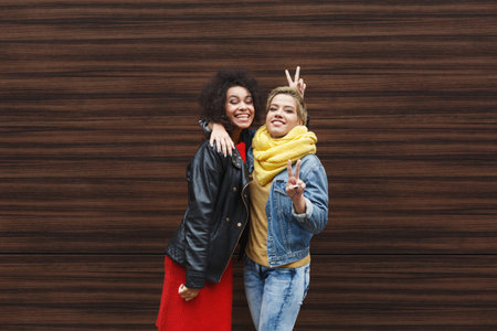 Friends Posing Together in a Collage Format Against a Wooden Wall Outdoors in a City Setting
